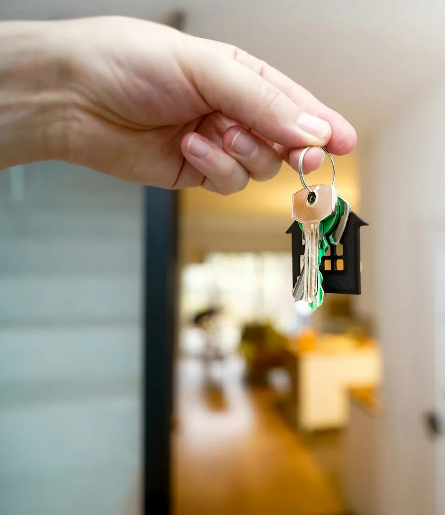 House keys held in front of an entrance